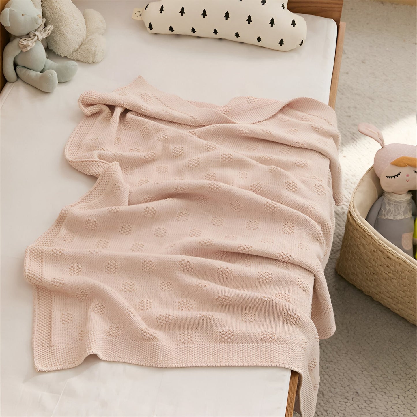 OEKO-TEX® Blush Plaid Knitted Cotton Blanket - Draped on side of bed with teddies - Bambisserie