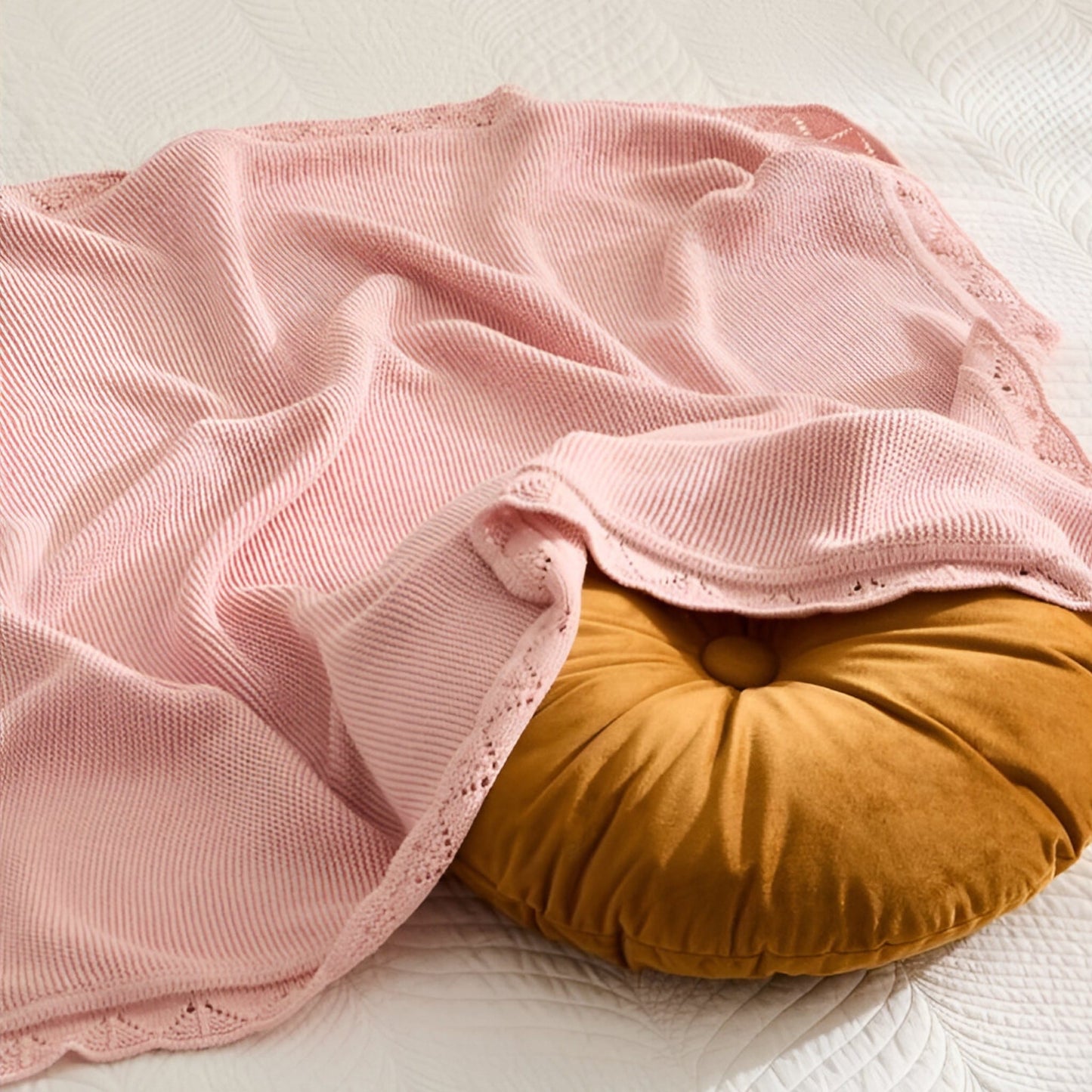 OEKO-TEX® Lullaby Knitted Cotton Blanket, Blossom - Draped on bed with round pillow - Bambisserie