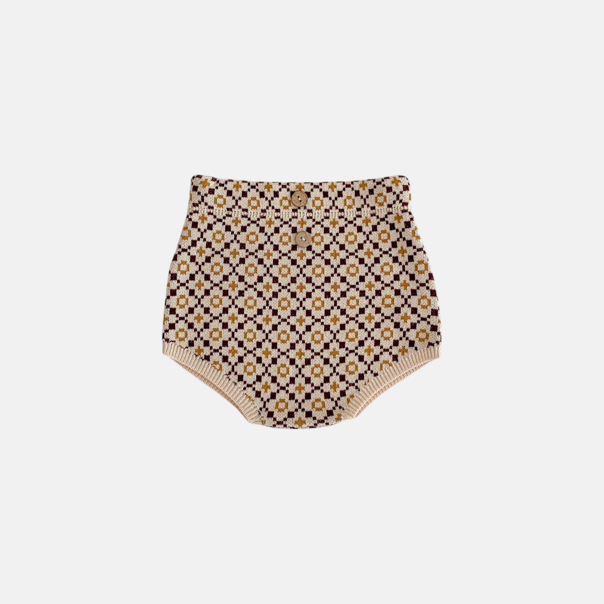 Patterned brown knitted baby bloomers on a white background