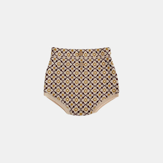 Patterned brown knitted baby bloomers on a white background