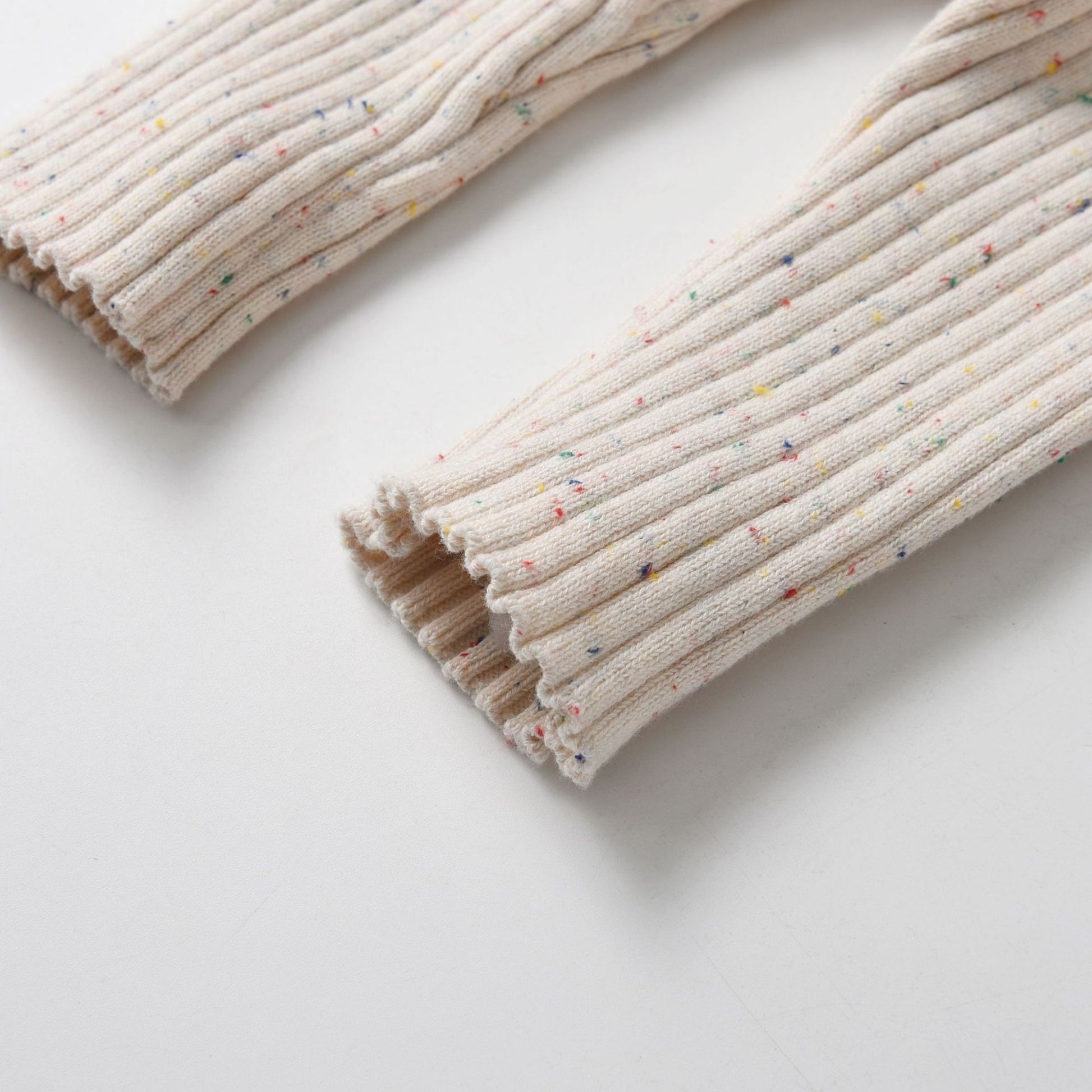 Almond Speckle Knitted Cotton Baby Jumpsuit Leg Detail - Bambisserie