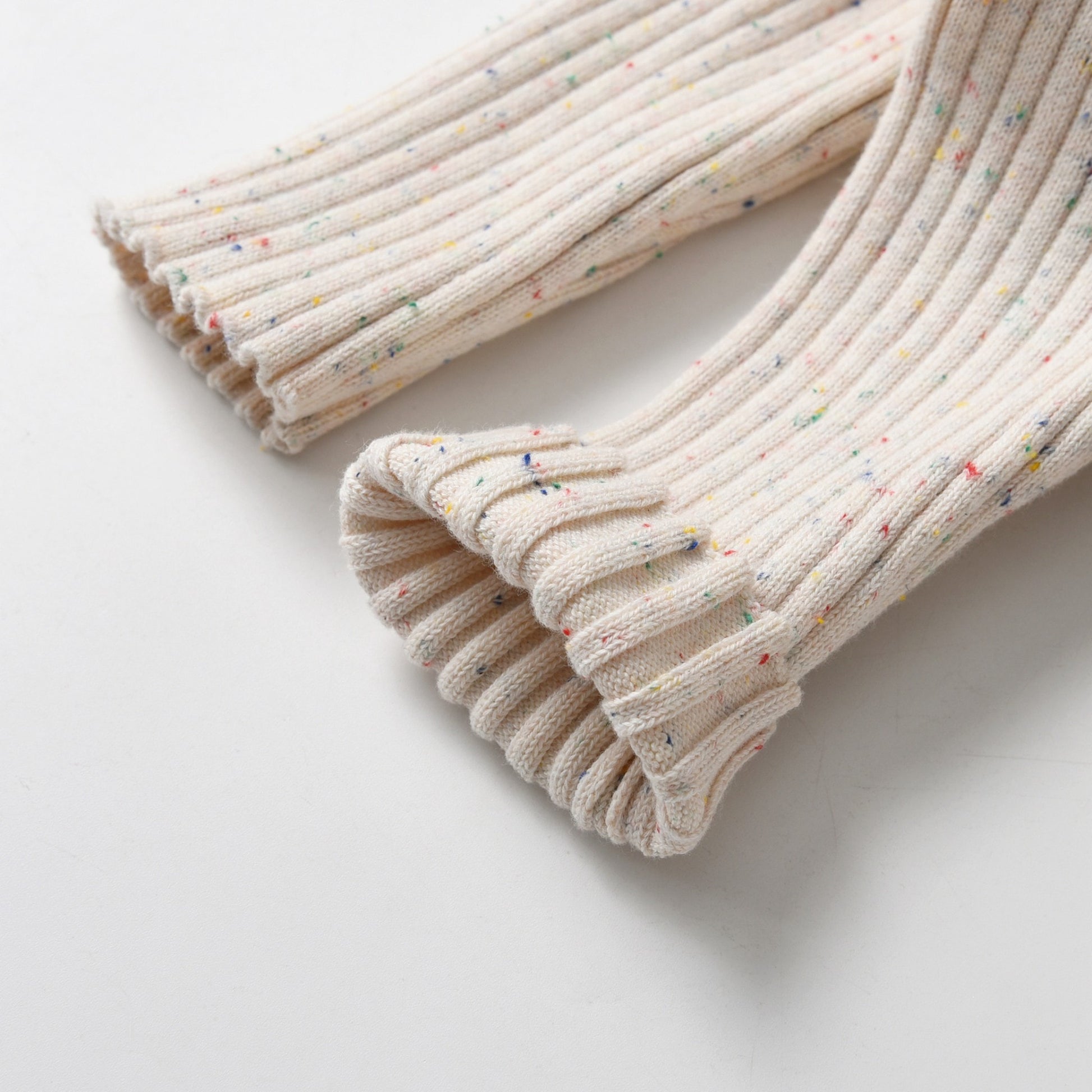 Almond Speckle Knitted Cotton Baby Jumpsuit Leg Detail Folded Up - Bambisserie