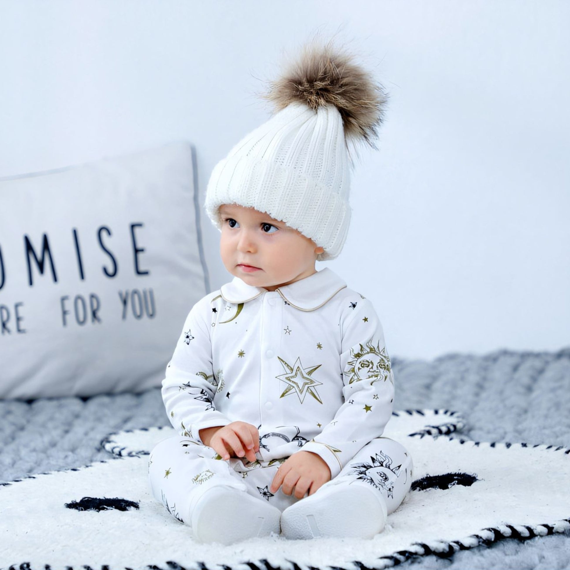 Baby sitting up wearing Apollo Sun GOTS Organic Cotton Baby Sleepsuit - Bambisserie