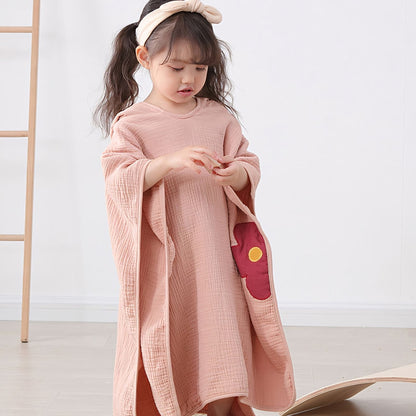 Girl in pigtails wearing Little Flower Cotton Hooded Towel Poncho, Apricot - Bambisserie