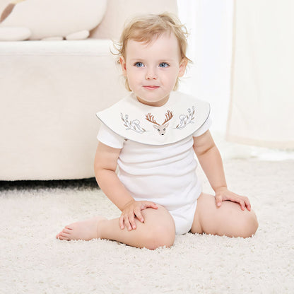 Embroidered Deer Cotton Waterproof Dribble Bib worn by toddler sitting on carpet - Bambisserie