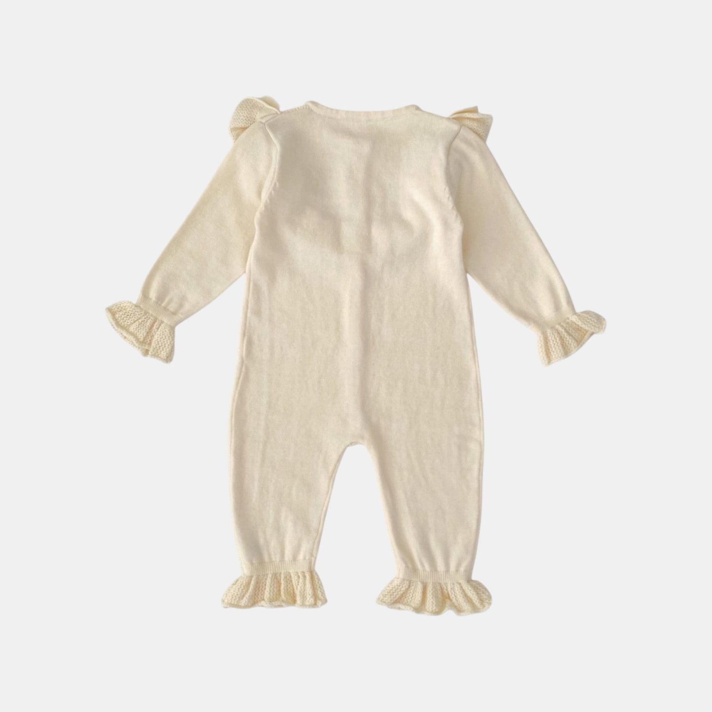Back of cream baby romper with ruffled sleeves and legs on a white background