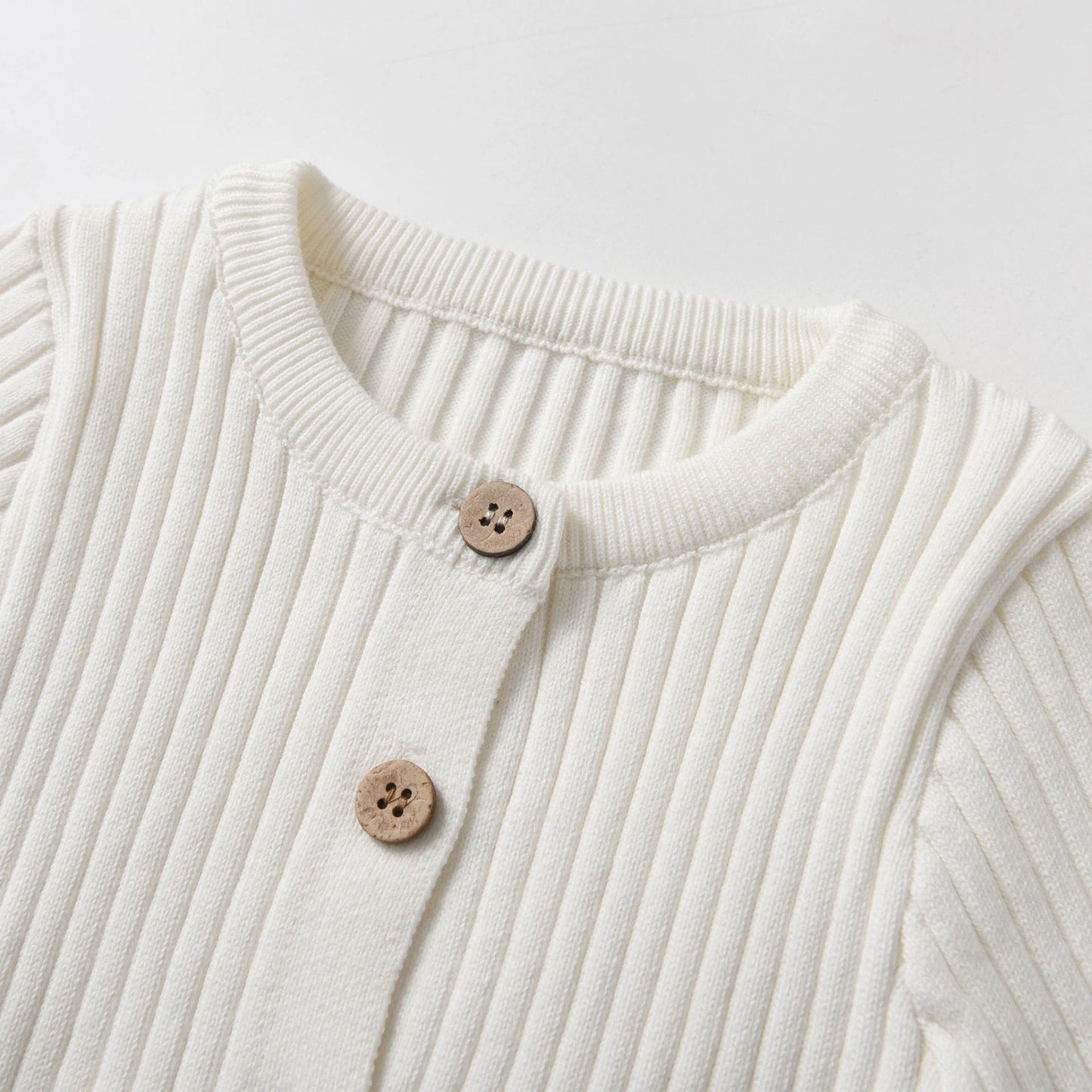 Ivory Knitted Cotton Baby Jumpsuit - Front Neckline Detail - Bambisserie