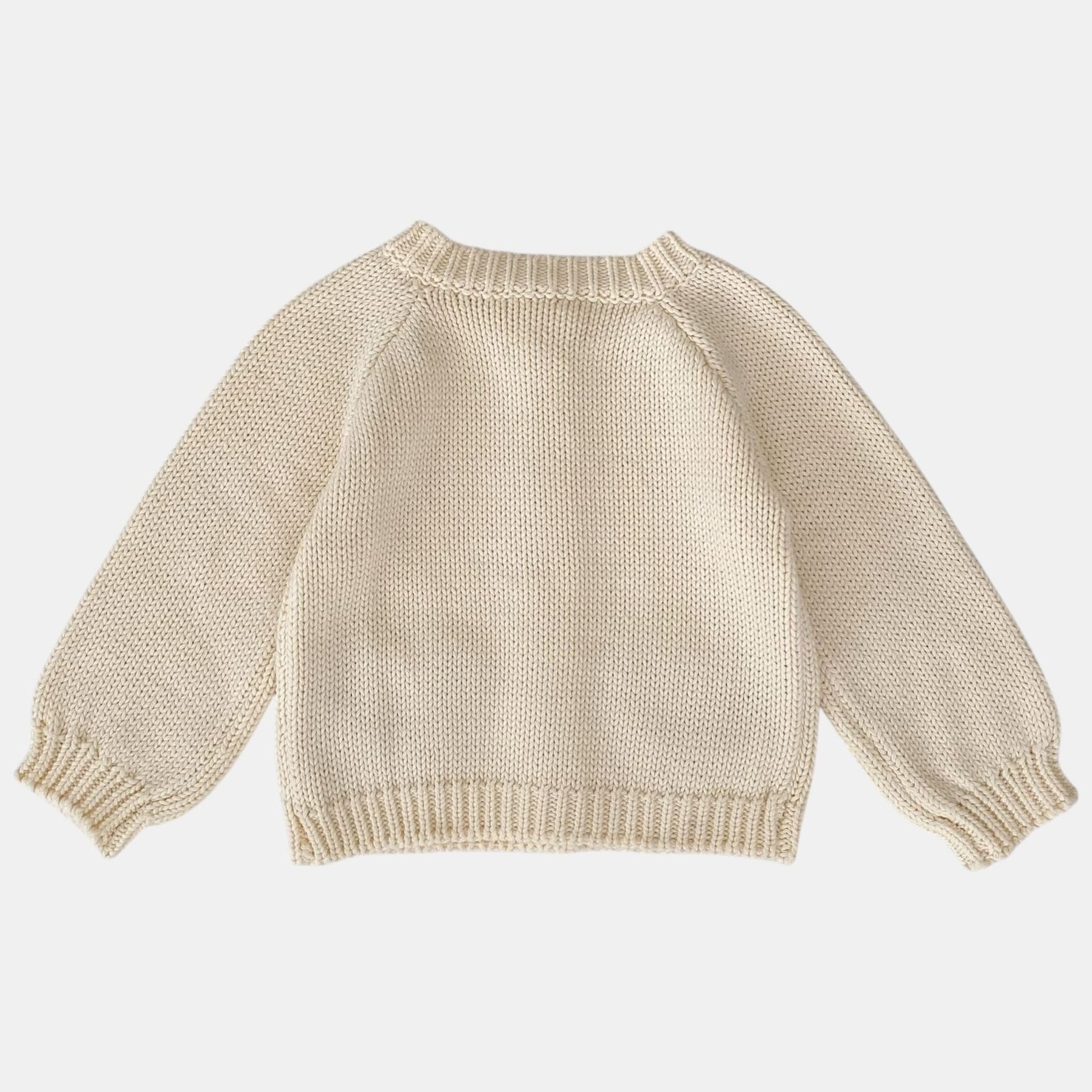 Cream knitted cardigan on a white background