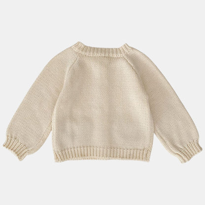 Cream knitted cardigan on a white background