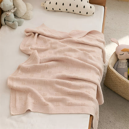 OEKO-TEX® Blush Plaid Knitted Cotton Blanket - Draped on side of bed with teddies - Bambisserie