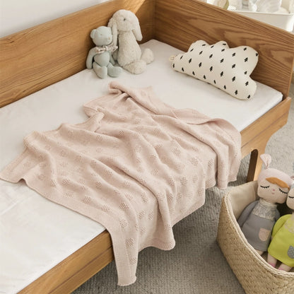 OEKO-TEX® Blush Plaid Knitted Cotton Blanket - Draped on side of bed - Bambisserie