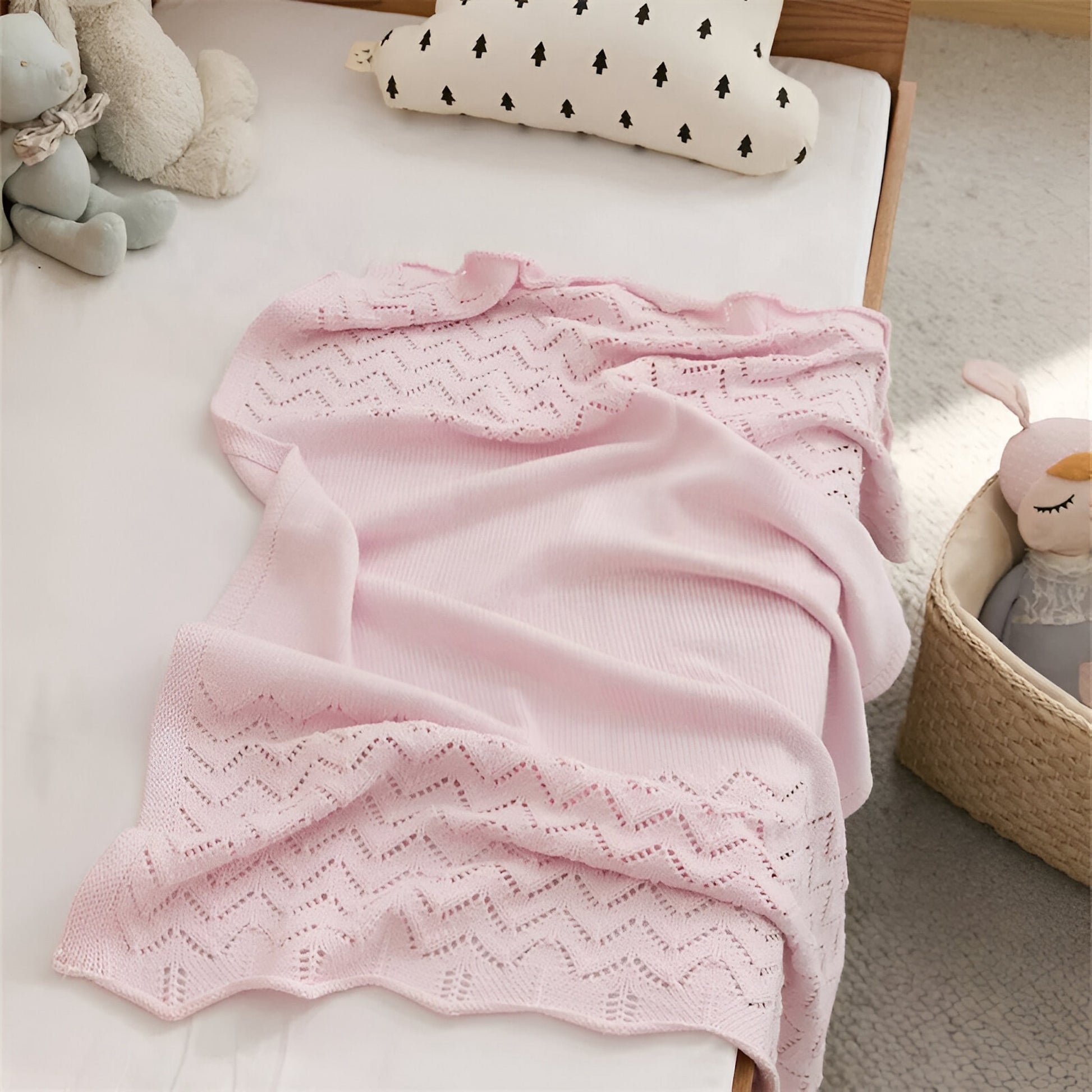 OEKO-TEX® Pink Chevron Knitted Cotton Blanket - Draped on side of bed - Bambisserie
