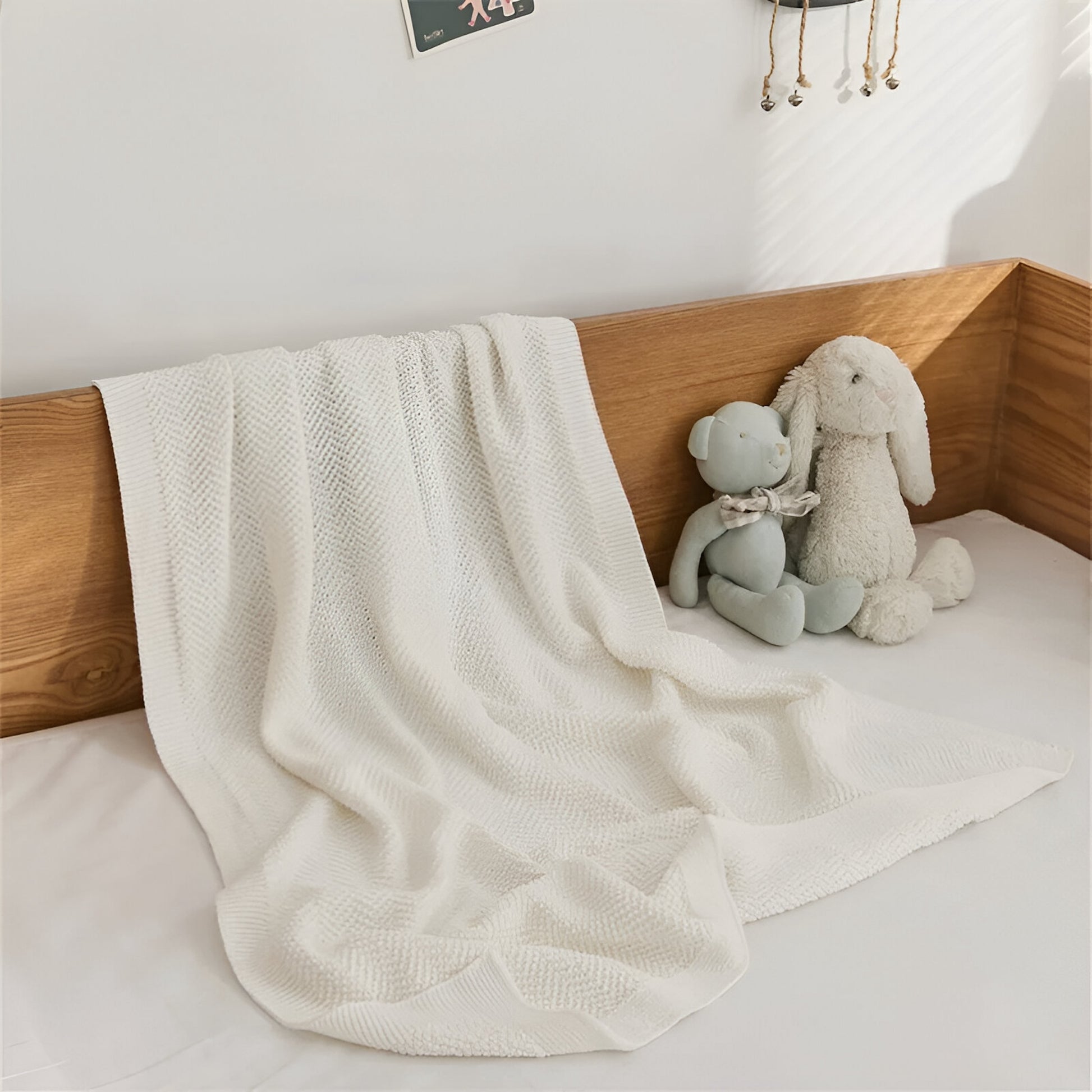 OEKO-TEX® White Waves Knitted Cotton Blanket - Draped on bed - Bambisserie
