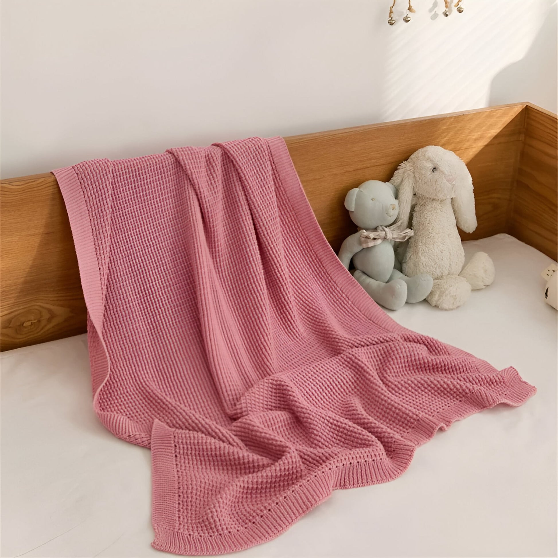 OEKO-TEX® Pink Waffle Knitted Cotton Blanket - Draped on bed - Bambisserie