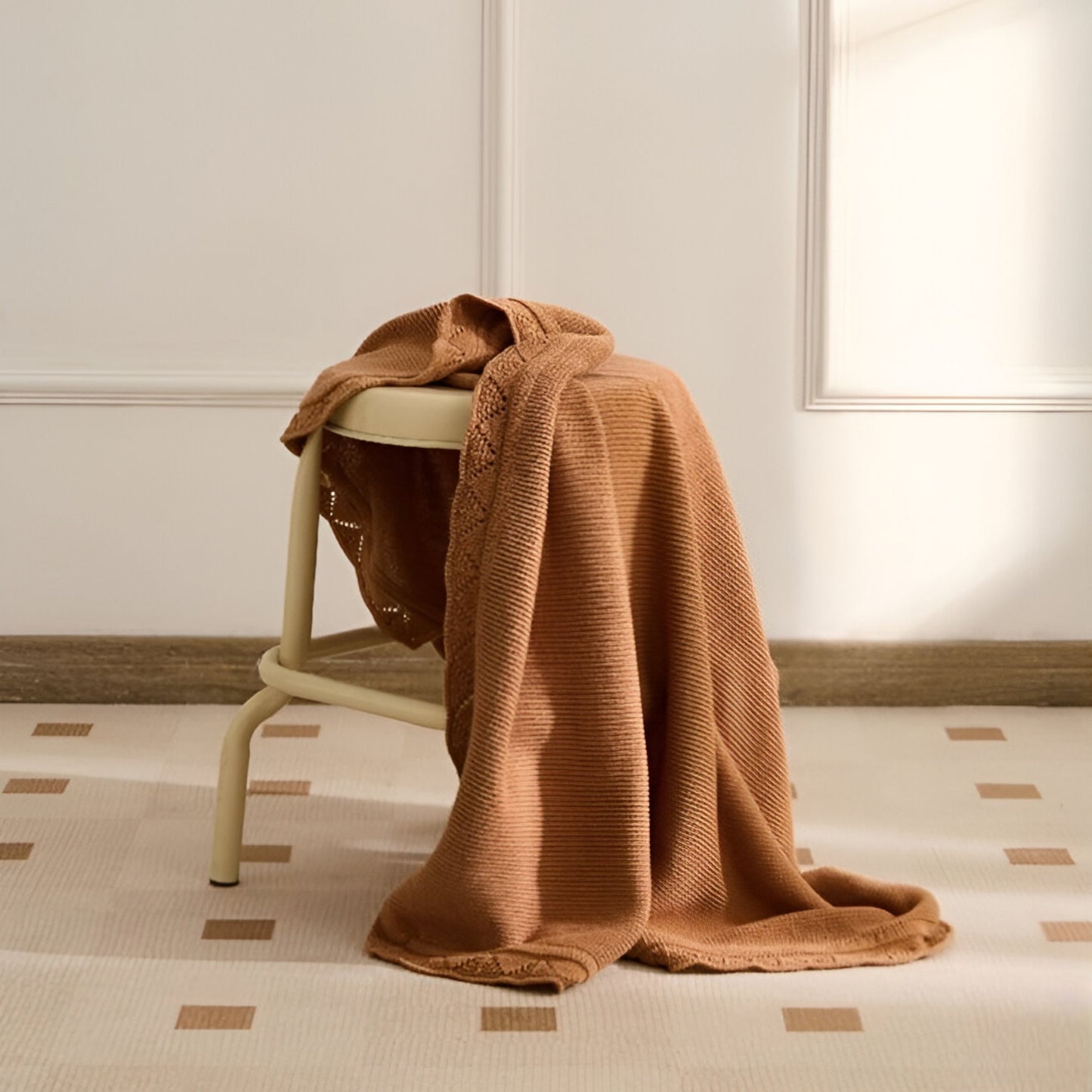 OEKO-TEX® Lullaby Knitted Cotton Blanket, Hazelnut - Draped on stool - Bambisserie