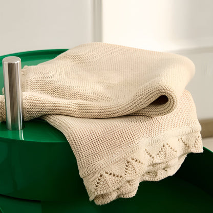 OEKO-TEX® Lullaby Knitted Cotton Blanket, Oat - On green table - Bambisserie