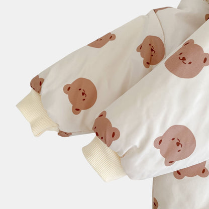 Cream pramsuit sleeves with brown bear prints on a white background