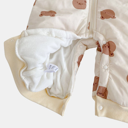 Cream baby pramsuit with bear pattern on a white background