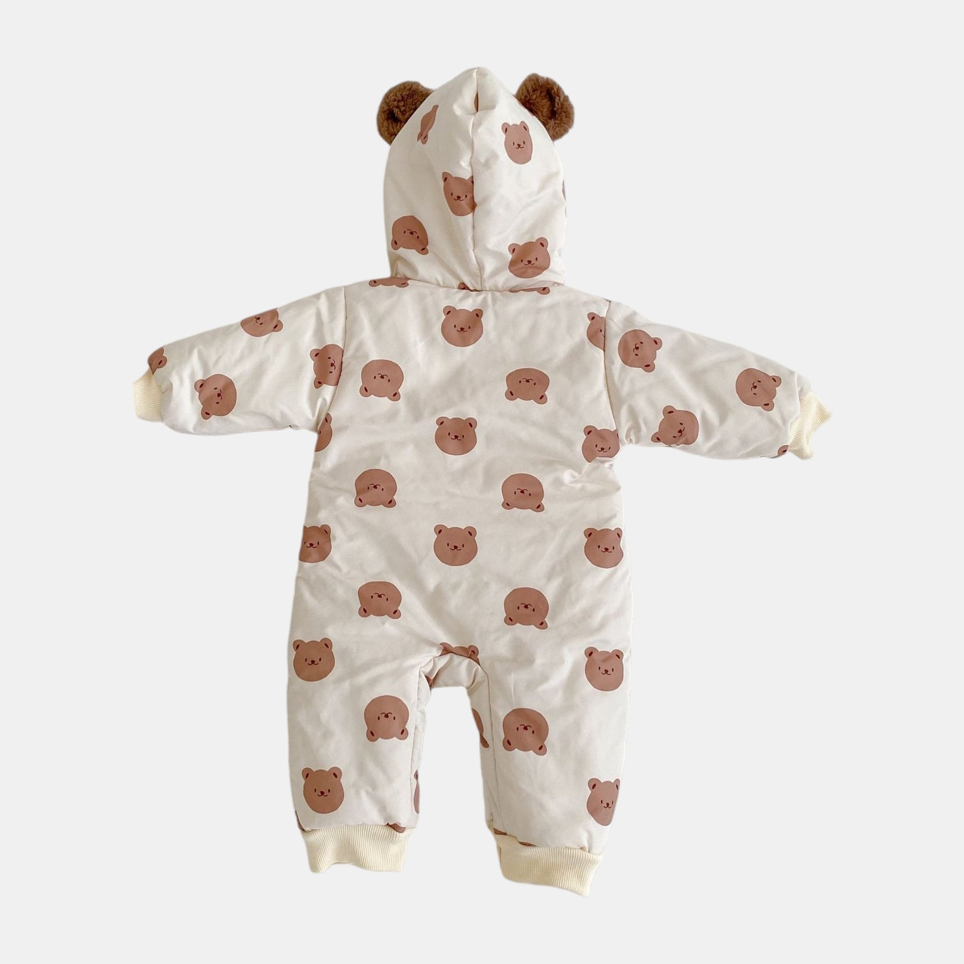 Cream baby pramsuit with bear pattern on a white background