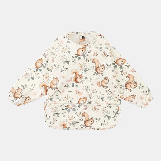 Baby feeding apron bib with squirrel pattern on a light background